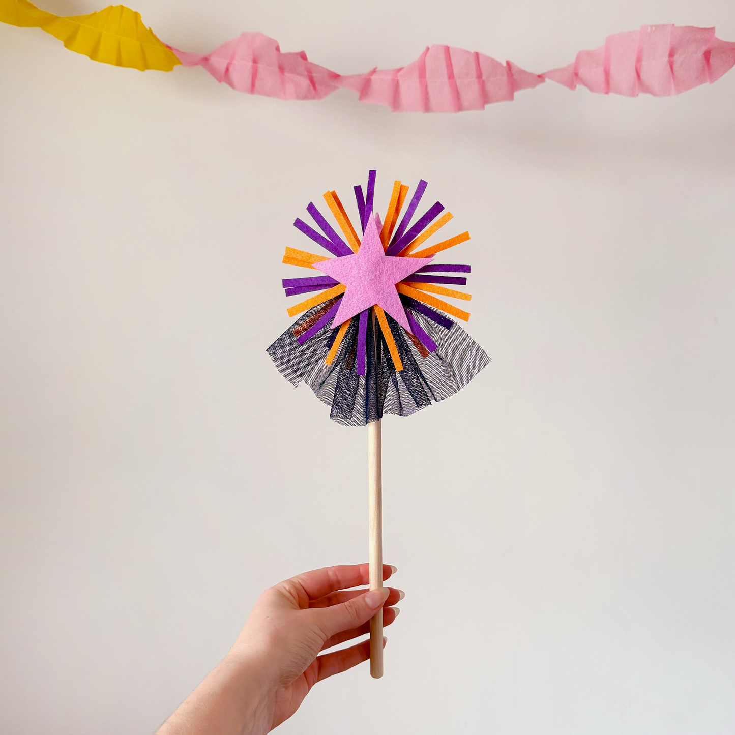 A handmade felt fairy wand featuring a pink star, purple details and blue sparkly netting. Great gifts for kids, dressing-up boxes, fancy dress and party bags. Bella & The Moon gifts and stationery.