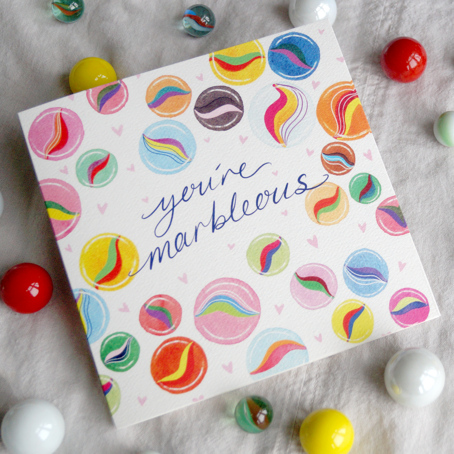 You're Marbleous greetings card featuring an array of nostalgic, colourful marbles and a marble related pun. Perfect for saying thank you, sending love, friendship, best friends, Mother's Day, Valentine's Day, birthday's and just because. 14cm x 14cm in size and printed on premium quality 300gsm card stock. Designed by luxury gifts and stationery brand, Bella & The Moon.