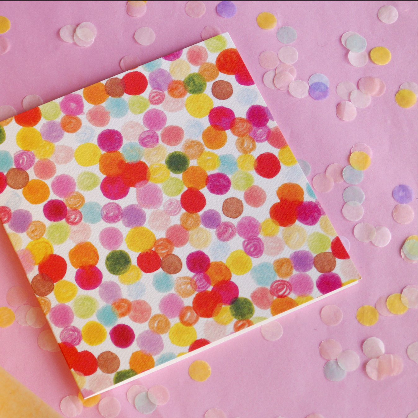 Birthday, just because or celebration card featuring an array of colourful dots and spots. Displayed on a pink background with confetti. 14cm x 14cm in size and printed on premium quality 300gsm card stock. Designed by luxury gifts and stationery brand, Bella & The Moon.