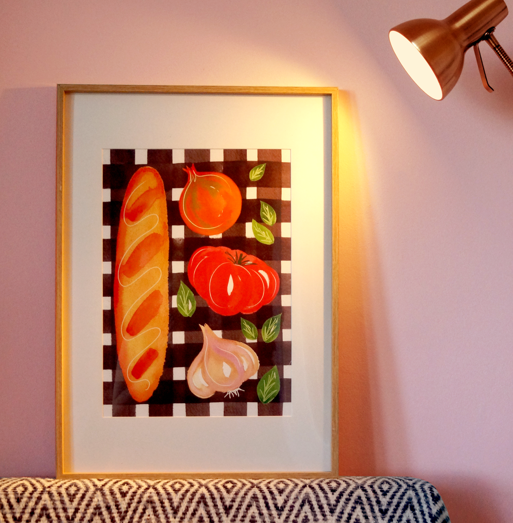 A textured A3 art print of a baguette, tomato, onion and garlic on a brown chequered tablecloth. Modern retro, kitchen and food themed wall art and home decor. Bella & The Moon gifts and stationery