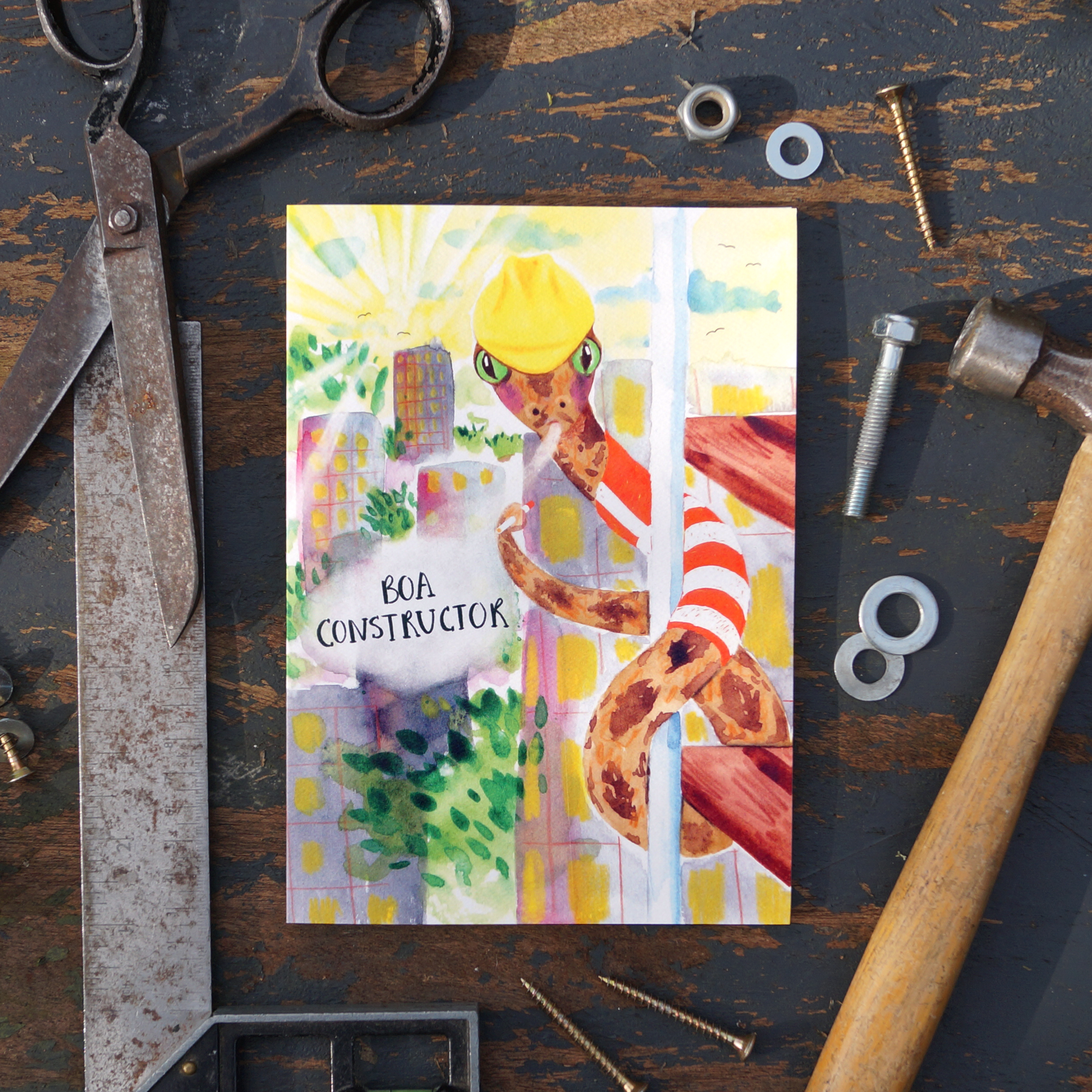 Boa Constructor, construction greetings card featuring a comical Boa-Constrictor wearing a high visibility jacket and hard hat, climbing scaffolding and smoking a cigarette. Perfect for construction workers, builders, handy men, road workers, birthday's, saying thank you or just to make someone laugh. A5 in size and printed on premium quality 300gsm card stock. Designed by luxury gifts and stationery brand, Bella & The Moon. 
