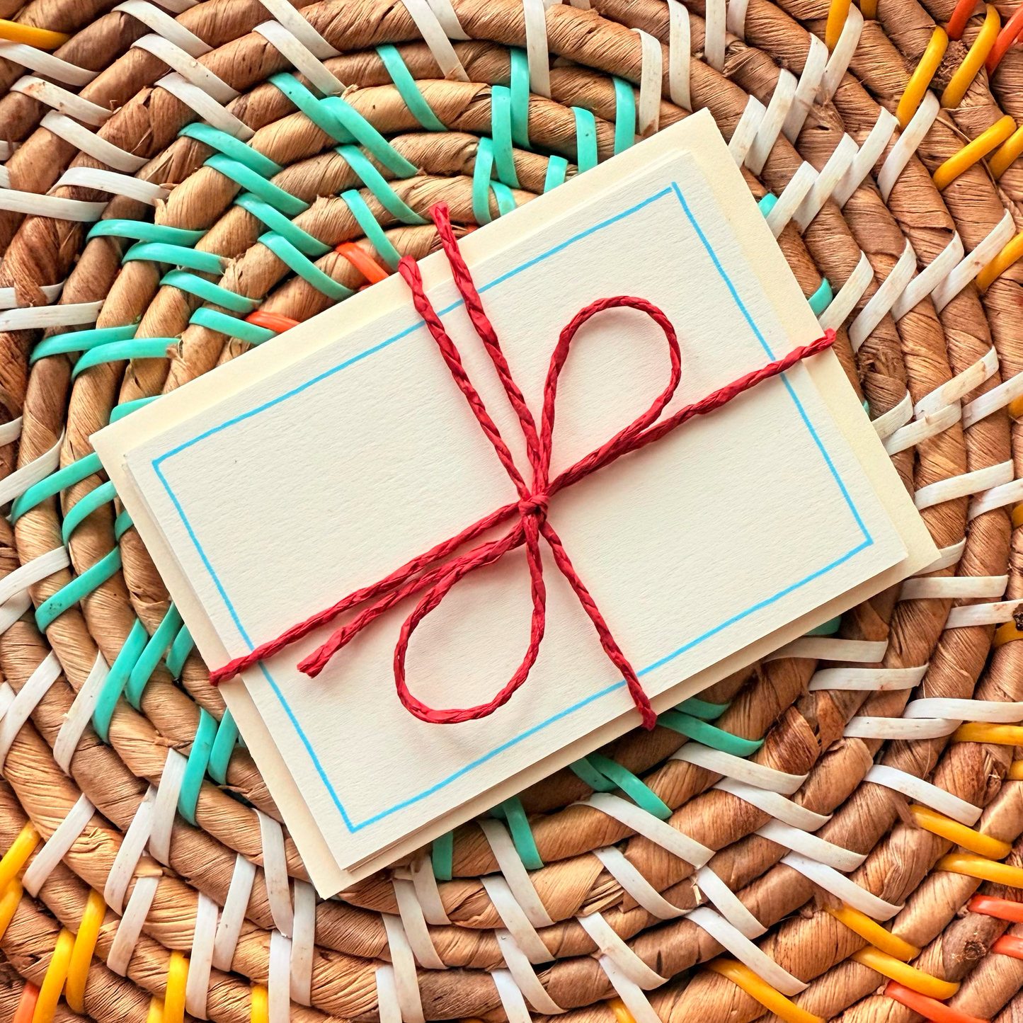 Blue border, hand detailed notecards tied with red string. Sets of 6 notecards and envelopes with hand detailed designs on each card. Gifts for birthdays or to send to friends. A7 in size. Bella & The Moon gifts and stationery