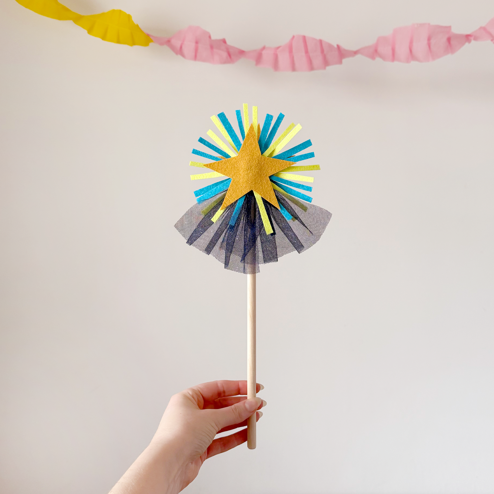 A handmade felt fairy wand featuring a gold star, blue details and blue sparkly netting. Great gifts for kids, dressing-up boxes, fancy dress and party bags. Bella & The Moon gifts and stationery.