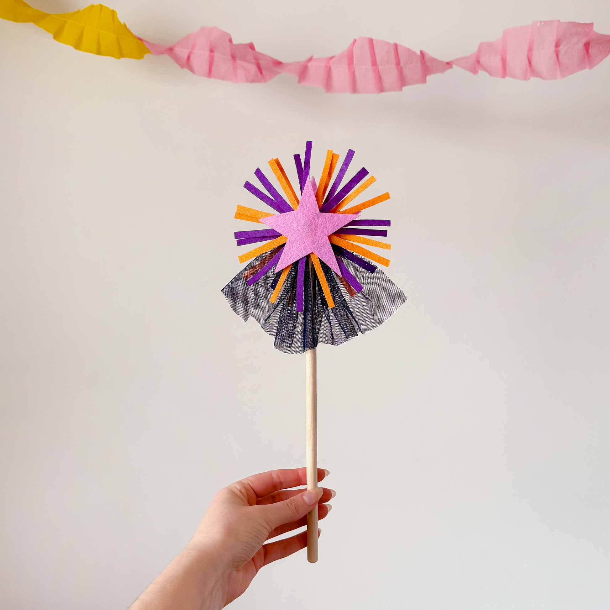 A handmade felt fairy wand featuring a pink star, purple details and blue sparkly netting. Great gifts for kids, dressing-up boxes, fancy dress and party bags. Bella & The Moon gifts and stationery.