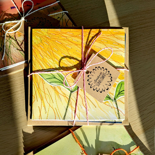 If Smiles Were Sunflowers Greetings Card Set. featuring a collection of colourful, floral, nature themed, embroidery illustrations. Each set of cards is hand tied with coloured string. Perfect for stationery lovers, card collectors, as gifts for loved ones, embroiders, art lovers, to say thank you, birthdays or just because. 14cm x 14cm, square in size and printed on premium quality 300gsm card stock. Designed by luxury gifts and stationery brand, Bella & The Moon.