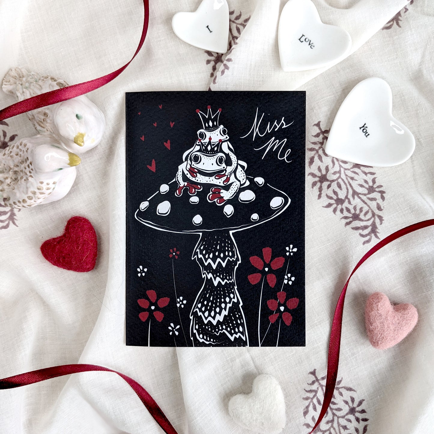 Kiss Me - Frogs greetings card featuring cute frog illustration and love-themed design, perfect for Valentine's Day, anniversaries, or romantic celebrations, A6 size, 300gsm premium card stock, designed by Bella & The Moon.