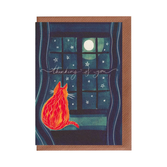 Greeting card with a cat looking out a window at the moon in the night sky, featuring the text 'thinking of you'. A thoughtful encouragement or sympathy card for loved ones. A6 in size. Bella & The Moon gifts and stationery.