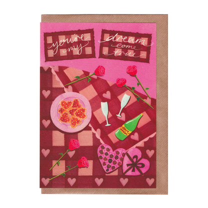 Valentine's Day card featuring a romantic  pink and red illustration of a bed decorated with roses, champagne, cookies and chocolates. A5 is size and printed on premium quality 300gsm card stock. Designed by luxury gifts and stationery brand, Bella & The Moon. 
